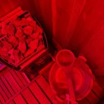 Interior of Calor Sauna Studios treatment room with red infrared lighting