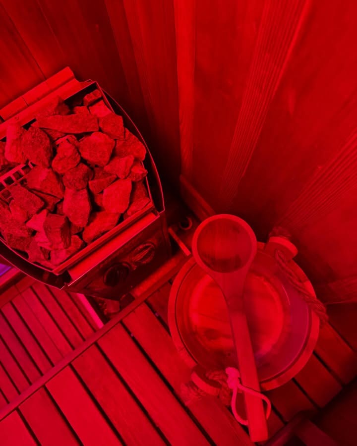 Interior of Calor Sauna Studios treatment room with red infrared lighting